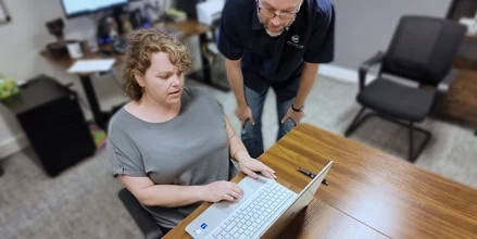 A White Whale Web project lead training a client on updating her website.