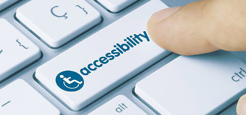 Finger pressing an accessibility key on a computer keyboard highlighting how AI built websites fail ADA compliance and accessibility standards