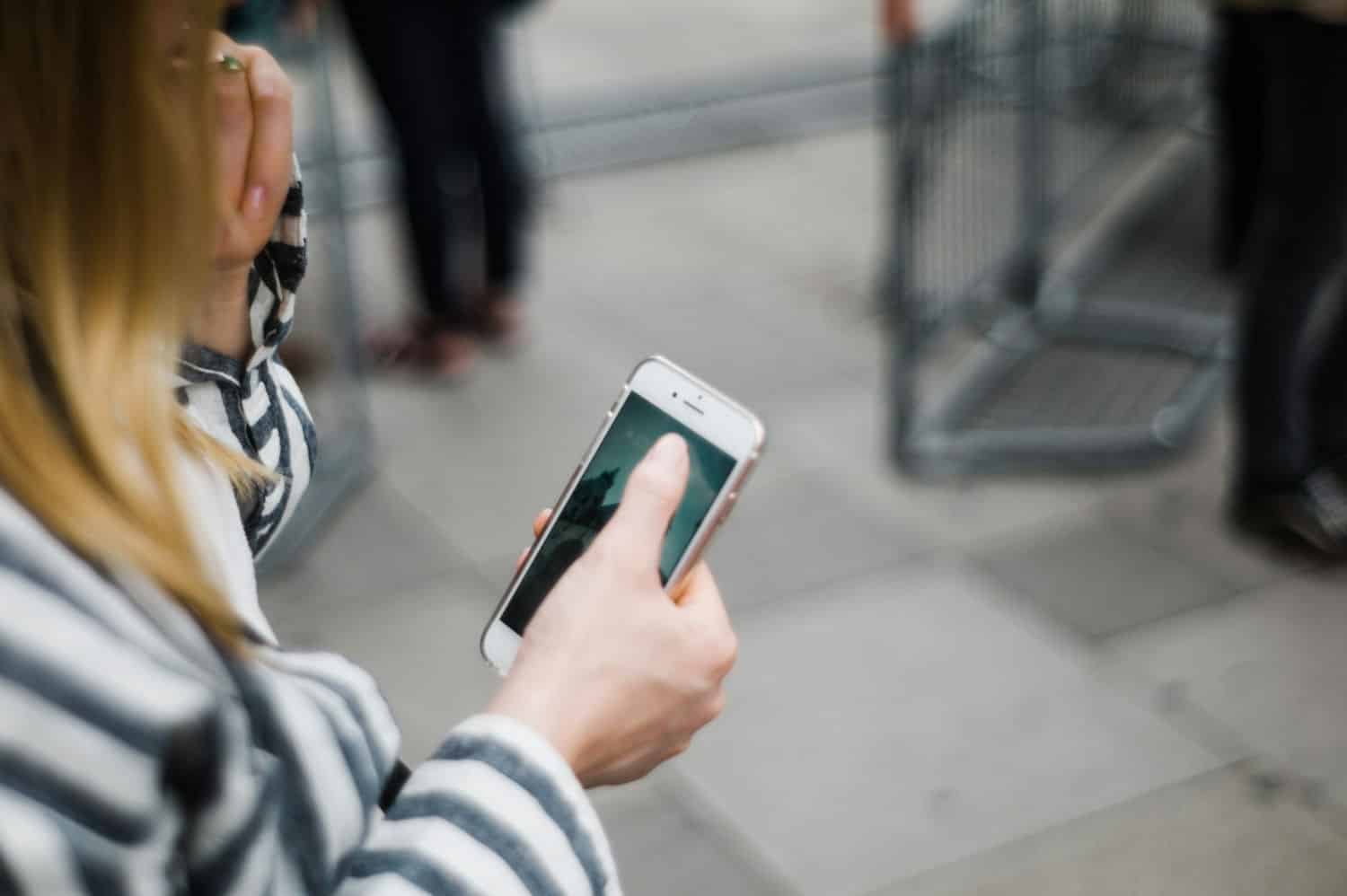 Person using a smartphone to access city website services on mobile.